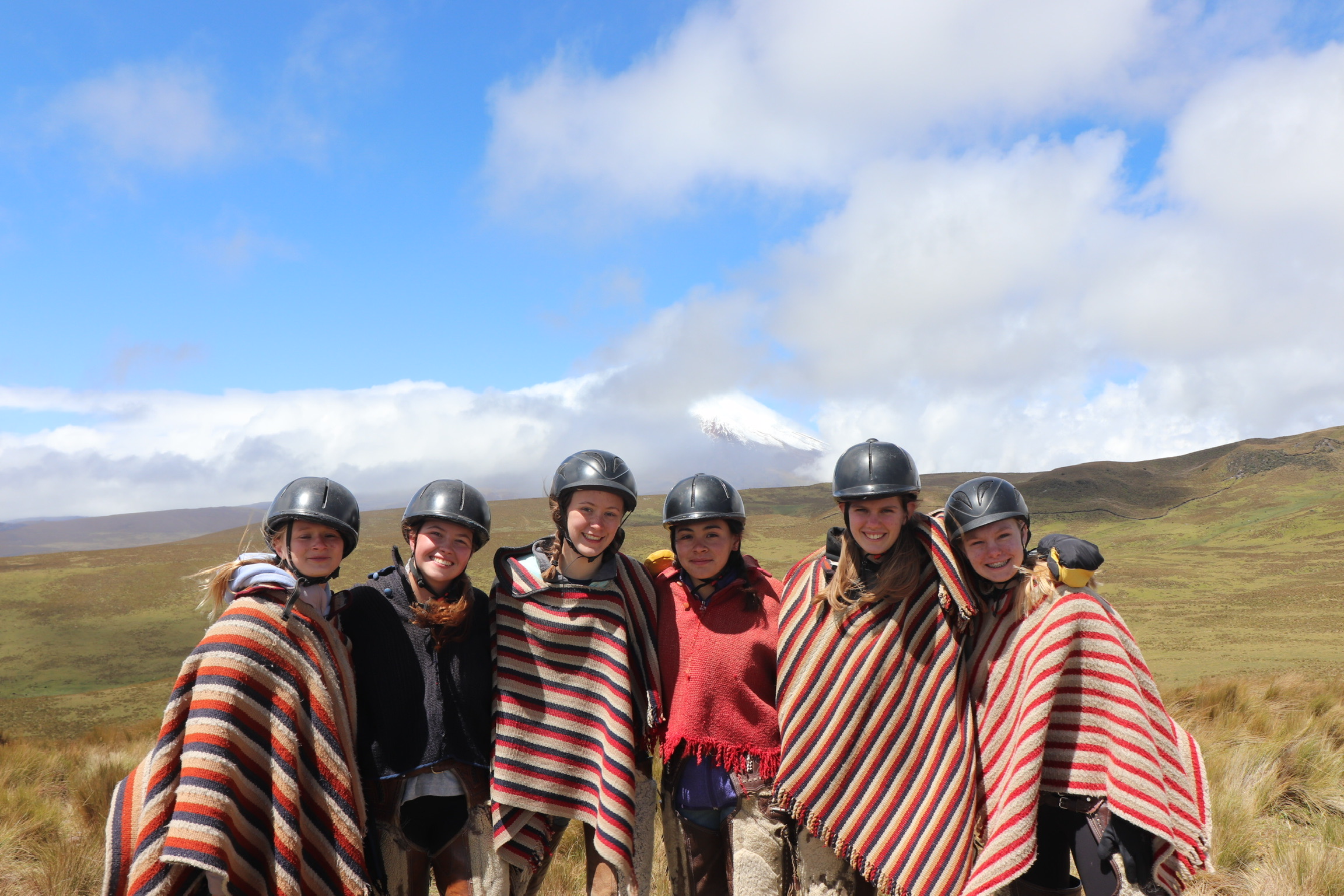 students wearing helmets smiling in group