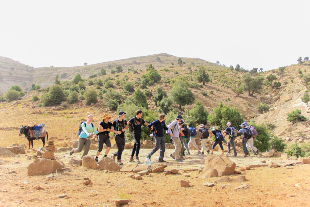 group-students-hike-dance-donkey