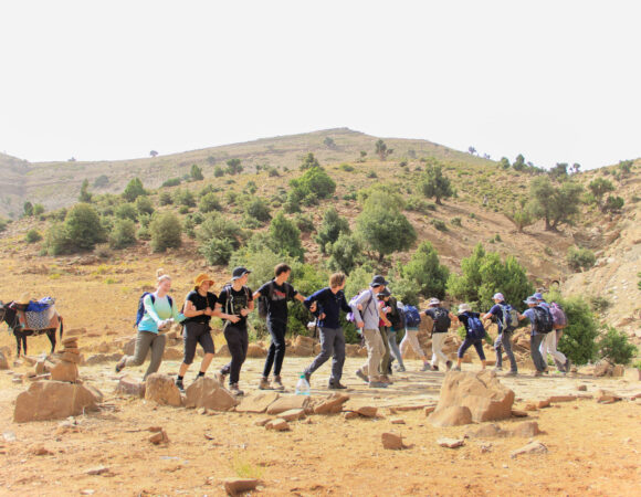 group-students-hike-dance-donkey