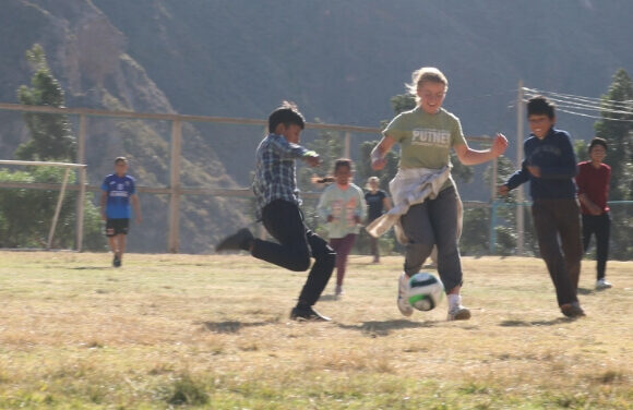 student-playing-soccer-with-local-families