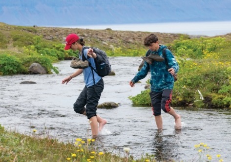 students-crossing-stream-iceland