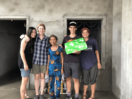 putney students with the recipient of the new home