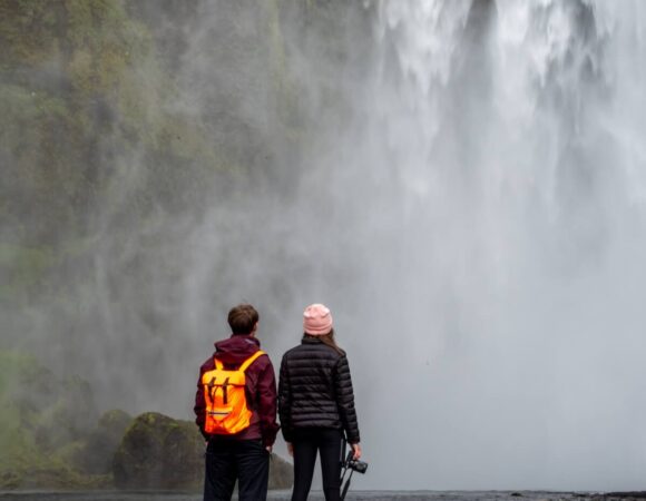 two-students-beneath-waterfall-iceland